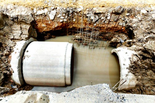 flooded hole with concrete water pipe
